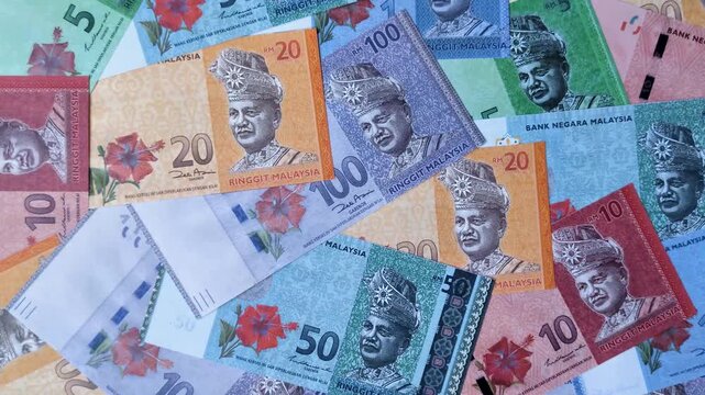 Malaysian ringgit banknotes as a tool for trade and financial transactions. The Malaysian ringgit as a background for your design