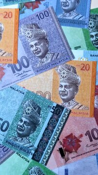 Malaysian ringgit banknotes as a tool for trade and financial transactions. The Malaysian ringgit as a background for your design