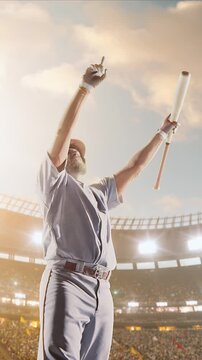 Baseball batter full swing follow-through with bat raised under golden daytime sky
