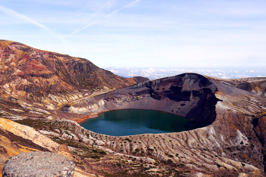 Okama Crater Lake on the sunny day. While local people call it affectionately Okama, the visitors tend to call it "Five Color Pond", because its color changes.