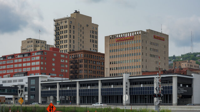 Duluth, MN, USA - July 25, 2026: Downtown Duluth, Minnesota cityscape featuring historic brick architecture, modern office buildings, and a multi-level concrete parking ramp structure.