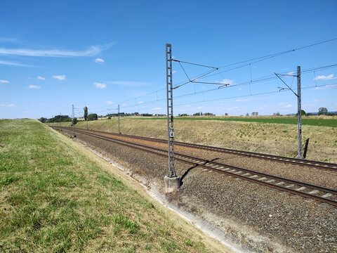 Electrified Railway Tracks Through Open Countryside