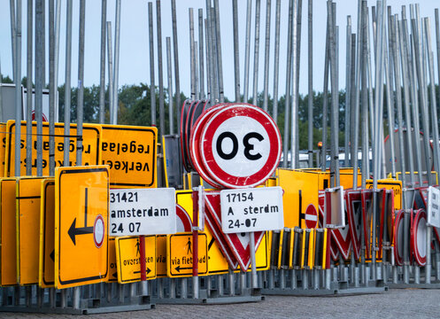 View of a collection of various traffic signs including speed limit signs and directional signs stored in a depot in Zaandam, North Holland, Netherlands.