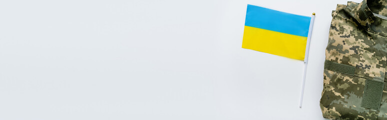 Fototapeta premium A small Ukrainian flag beside camouflage gear symbolizes national pride on August 24.