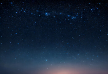 Naklejka premium Dark blue night sky with countless bright stars and a subtle glow on the horizon astronomy and space exploration, a subtle glow appears on the horizon the approach of dawn or distant light pollution