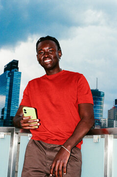 Man holding smartphone outdoors with sky film photo