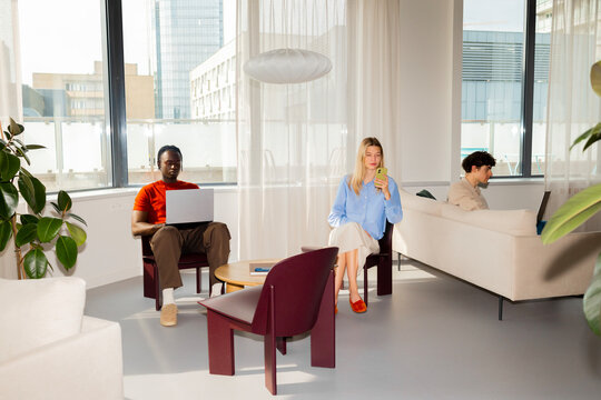 Modern Office Lounge with Laptops and Smartphone