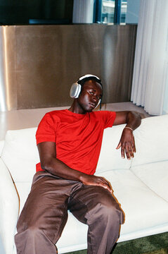 Man with headphones enjoying music in lounge on film photo