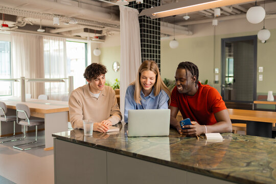 Teamwork with laptop in modern coworking office