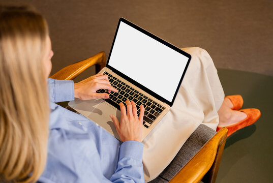 Business woman working on laptop with white screen mockup