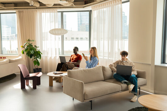 Business teamwork in coworking office with laptops and smartphone