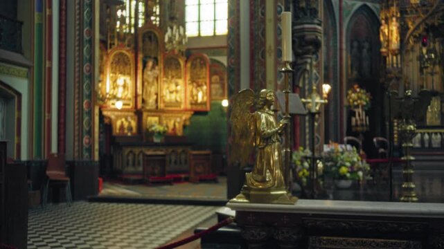 Ornate church interior with blurred background showcasing golden angel statue and vibrant stained glass, capturing an atmosphere of worship and tranquility.