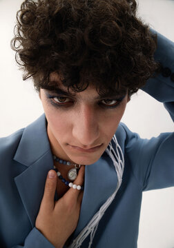 The fashion portrait of a curly man.