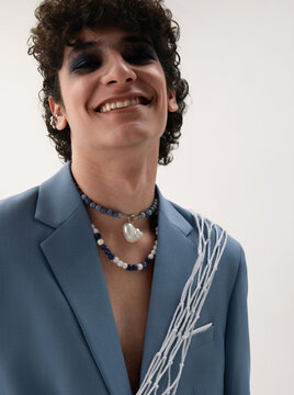 The fashion portrait of a smiling curly young man.