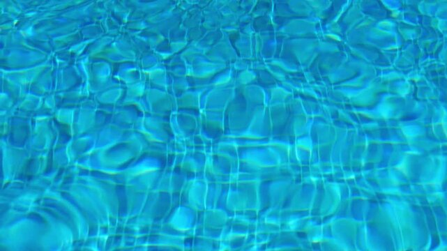 Abstract turquoise water texture with shimmering glare and circles