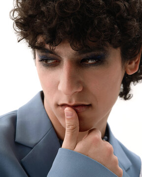 The fashion portrait of a curly man.