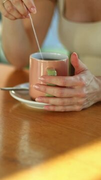 Close up of man and woman hands holding coffee and tea cups
