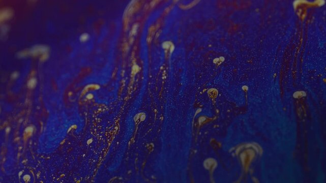 Dark abstract liquid texture with vibrant blue and gold fluid motion organic background