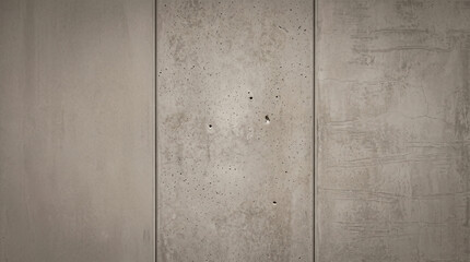 Fototapeta premium Weathered concrete wall with vertical panels and textured surface