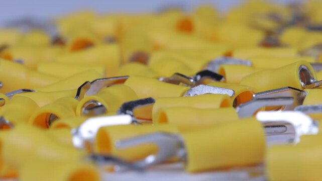 Metal tips with a plastic base for mounting on stranded copper wires. Close-up. Soft focus. Macro.