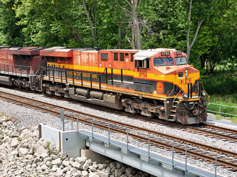 Savanna, Illinois June 23, 2026 Kansas City Southern locomotive 4794, leads a freight train through a lush, tree‑lined corridor on a double‑track mainline.
