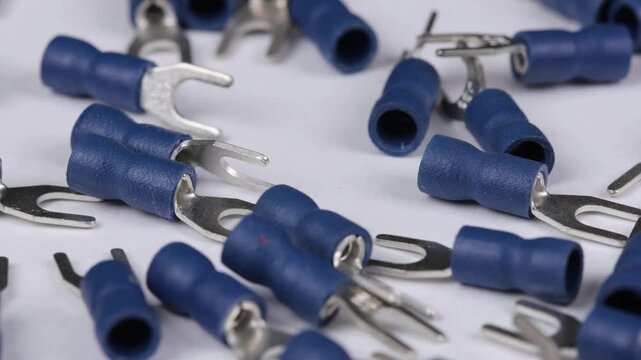 Metal tips with a plastic base for mounting on stranded copper wires. Close-up. Soft focus. Macro.