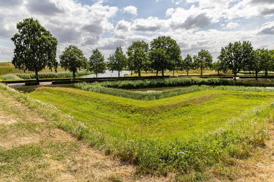 View of the historic grassy ramparts and moat surrounding the fortified town of Heusden, North Brabant, Netherlands.