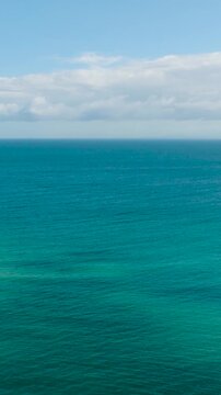 Aerial view of blue sea surface and turquoise water with corals. Santa Fe, Tablas, Romblon. Philippines. Vertical view.
