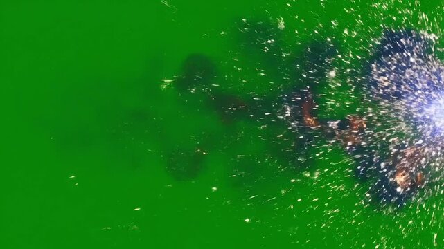 Vibrant green water surface disturbed by an unseen force creating dynamic ripples and splashes.