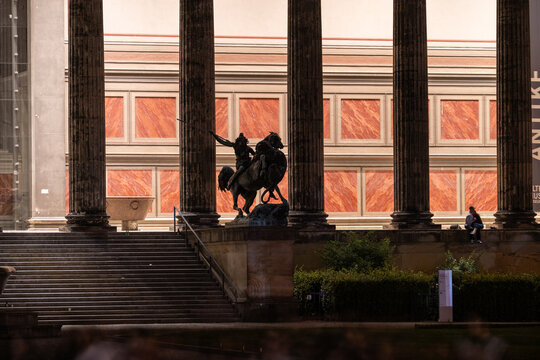View of the Lustgarten with the Altes Museum columns, the Amazon on Horseback statue, and people sitting on the steps in Berlin, Berlin, Germany.