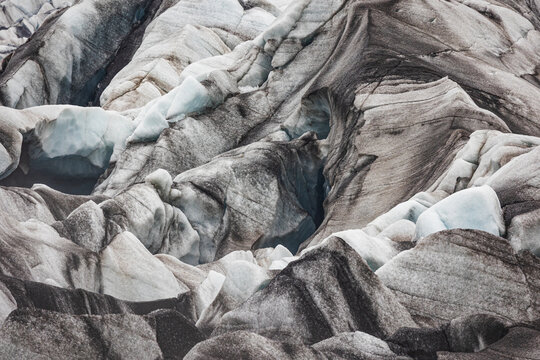 View of the striated ice formations and volcanic ash layers at Jokulsarlon glacier in Sveitarfelagid Hornaf, Iceland.