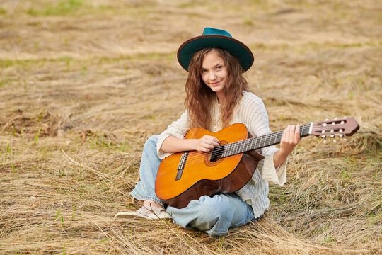 Teen girl playing guitar