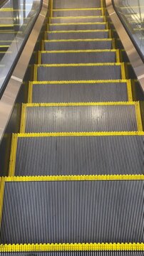 At the feet of a descending escalator