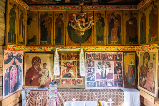 View of the ornate iconostasis inside a historic wooden church at the Kizhi Pogost, featuring traditional religious icons and paintings in Petrozavodsk, Republic of Karelia, Russia.