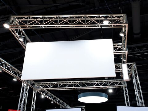 Empty stage with blank projection screen ready for presentation. Large white LED display backdrop for corporate events and conferences.