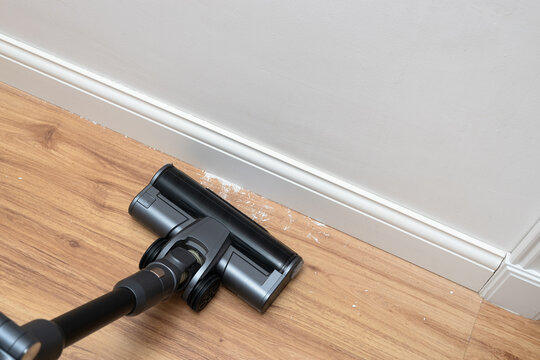 Vacuum cleaner brush cleaning the floor after renovation