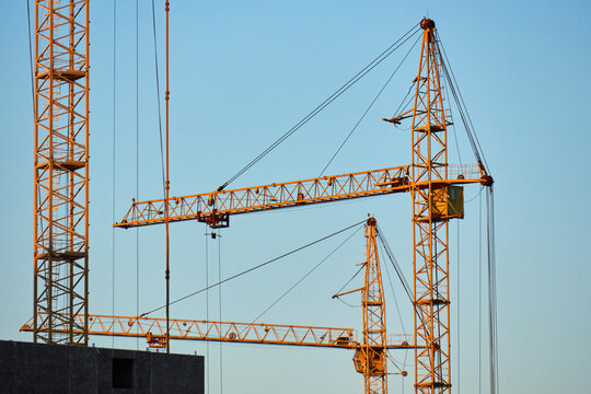 Industrial crane in action at a skyscraper construction site
