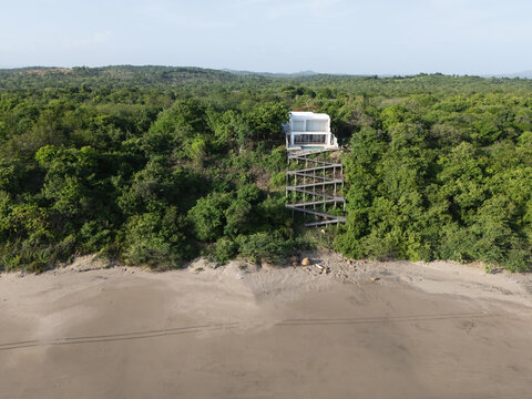 Beach shore with house on cliff