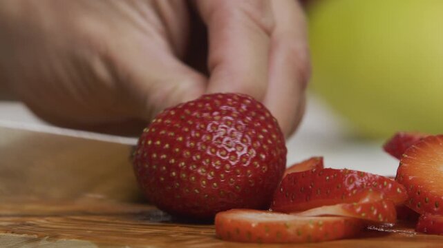 Juicy strawberry being sliced - Extreme closeup shot