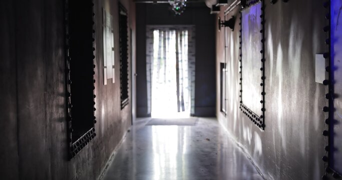 Dark mysterious hallway leading to bright light window
