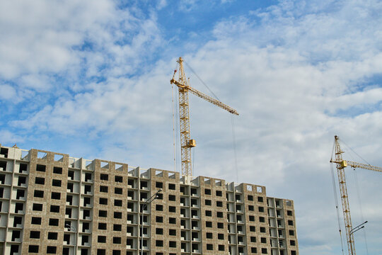 Outdoor day photography of a construction site showing a heavy lift crane arm extended