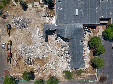Aerial view of a demolition site with heavy machinery and debris in Thornton, Colorado, United States.