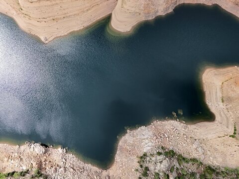 Aerial view of Gross Reservoir with deep blue water and rocky shorelines in Boulder County, Colorado, United States.