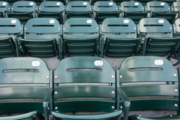 Fototapeta premium High-resolution photograph of empty seating at a professional baseball stadium with the baseball field visible in the background. 