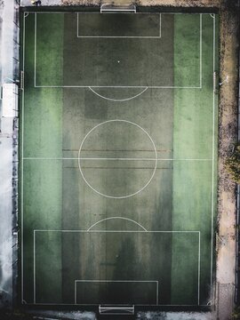 Aerial view of a soccer field with green artificial turf and white boundary lines in Lisbon, Portugal.