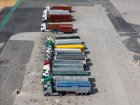 Aerial view of long haul trucks parked in rows in a logistics yard in Alges, Lisbon, Portugal.