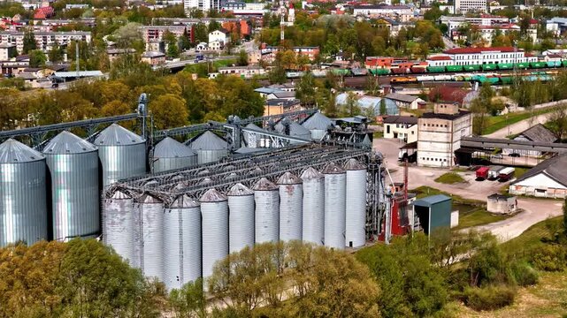 Aerial view of industrial grain silos and railway infrastructure in the city of Riga, Latvia.