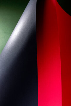 Abstract background of colored paper sheets on a black background