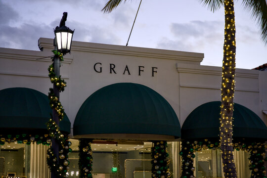 A close up view shows the Graff boutique facade decorated with holiday lights