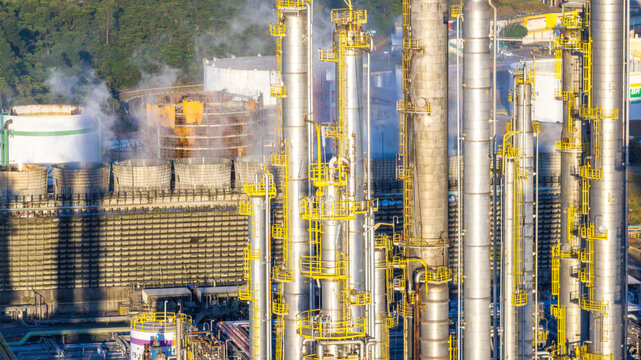Aerial view of the petrochemical complex with tall industrial towers, storage tanks, and steam rising from cooling units in Santo Andre, State of Sao Paulo, Brazil.
